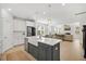 Spacious kitchen with stainless steel appliances, an island with a farmhouse sink, and a view of the living area at 113 Grimball St, Summerville, SC 29486