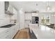 Stylish kitchen with white cabinets, stainless steel appliances, a farmhouse sink, and a dining area at 113 Grimball St, Summerville, SC 29486