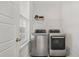 Well-lit laundry room with stainless steel washer and dryer, plus shelving and window at 113 Grimball St, Summerville, SC 29486
