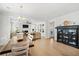 Open-concept living room with hardwood floors, a cozy fireplace, and natural light from large windows at 113 Grimball St, Summerville, SC 29486