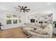Bright, open living room with hardwood floors, large windows, and comfortable sectional sofa at 113 Grimball St, Summerville, SC 29486