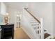Bright foyer features wood staircase, hardwood floors, and a half bath, creating a welcoming entry at 113 Grimball St, Summerville, SC 29486