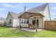 Well-maintained backyard with a patio, covered dining area, lush lawn, and landscaped garden beds at 117 Back Tee Cir, Summerville, SC 29485