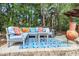 Relaxing backyard seating area with comfortable cushions and a vibrant blue and white outdoor rug at 117 Back Tee Cir, Summerville, SC 29485