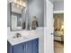 Elegant bathroom vanity with blue cabinets, a modern mirror, and stylish fixtures at 117 Back Tee Cir, Summerville, SC 29485
