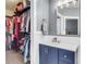 Well-organized bathroom with blue vanity, mirror, and walk-in closet with custom shelving at 117 Back Tee Cir, Summerville, SC 29485
