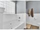 Bright bathroom featuring a soaking tub with white paneled walls and light filtering window blinds at 117 Back Tee Cir, Summerville, SC 29485