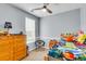 Cozy bedroom featuring a large window, ceiling fan, and playful decor at 117 Back Tee Cir, Summerville, SC 29485