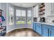 Bright breakfast nook with bay windows provides ample natural light, complemented by blue cabinets and stylish decor at 117 Back Tee Cir, Summerville, SC 29485