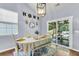 Cozy dining area with a decorative table and chairs, a pendant light, and access to the outdoor patio at 117 Back Tee Cir, Summerville, SC 29485