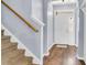 Bright entryway featuring hardwood floors, a staircase, and a view of the front door at 117 Back Tee Cir, Summerville, SC 29485