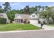 Inviting home featuring well-manicured lawn, brick accents, a two-car garage, and traditional architecture at 117 Back Tee Cir, Summerville, SC 29485