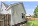 White home exterior with a backyard, garden and fenced area, creating a private outdoor space at 117 Back Tee Cir, Summerville, SC 29485