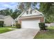 Home featuring a spacious two-car garage, brick accents, and a well-maintained lawn at 117 Back Tee Cir, Summerville, SC 29485