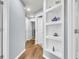 Bright hallway with hardwood floors, built-in shelving, and white trim, offering a clean, modern aesthetic at 117 Back Tee Cir, Summerville, SC 29485