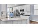 Bright kitchen features white cabinets, subway tile backsplash, stainless steel appliances, and an island with marble countertops at 117 Back Tee Cir, Summerville, SC 29485