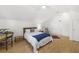 Bright bedroom with a wooden bed frame, blue accent blanket, and a peaked roofline at 1177 Old Ivy Way, Mount Pleasant, SC 29466