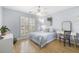 Light-filled bedroom with a ceiling fan, desk, and calming blue walls at 1177 Old Ivy Way, Mount Pleasant, SC 29466