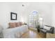 Bright bedroom with vaulted ceiling, soft light, and cozy armchair at 1177 Old Ivy Way, Mount Pleasant, SC 29466