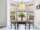 Charming breakfast nook with a wooden table, seating for four, and a bright bay window overlooking the lush outdoors at 1177 Old Ivy Way, Mount Pleasant, SC 29466