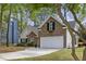 Charming two-story home with a brick facade, white garage door, and well-manicured landscaping in a lush, green setting at 1177 Old Ivy Way, Mount Pleasant, SC 29466