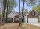 Beautiful home featuring a mix of brick and white siding, complemented by a two-car garage and mature trees at 1177 Old Ivy Way, Mount Pleasant, SC 29466