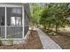 Charming side yard and path of home with screened in porch and view of landscaping and flowers at 1177 Old Ivy Way, Mount Pleasant, SC 29466