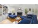 Elegant living room with a fireplace, built-in shelving, and plush blue seating, creating a cozy and inviting atmosphere at 1177 Old Ivy Way, Mount Pleasant, SC 29466