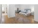 Cozy bedroom features wood flooring, light blue accents, and ensuite bathroom at 1177 Old Ivy Way, Mount Pleasant, SC 29466