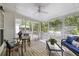 Inviting screened-in porch features ample seating and a ceiling fan for relaxing outdoors at 1177 Old Ivy Way, Mount Pleasant, SC 29466
