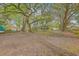 Expansive backyard with mature trees, a storage shed, and ample space for outdoor activities and landscaping at 1188 Camden St, North Charleston, SC 29405