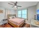 Neutral bedroom with wood floors, ceiling fan, light curtains and a wooden headboard at 1188 Camden St, North Charleston, SC 29405