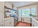 Updated kitchen features stainless steel appliances, white cabinets and bright window at 1188 Camden St, North Charleston, SC 29405