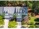 Overhead view of townhomes showcasing well-kept lawns, driveways, and proximity to surrounding trees and foliage at 120 Fresh Meadow Ln, Mount Pleasant, SC 29466