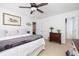 Bedroom featuring a comfortable bed, ceiling fan, a decorative lamp, and two entry doors at 120 Fresh Meadow Ln, Mount Pleasant, SC 29466