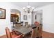 Dining room with rustic wood table, chandelier, and view into the kitchen area at 120 Fresh Meadow Ln, Mount Pleasant, SC 29466