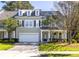 Charming townhome with a well-manicured lawn and attached garage, featuring classic architectural details at 120 Fresh Meadow Ln, Mount Pleasant, SC 29466