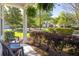 Covered front porch with patio seating and decorative hanging plants and surrounding landscaping at 120 Fresh Meadow Ln, Mount Pleasant, SC 29466