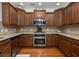 Kitchen with stainless steel appliances, wood cabinets, and neutral countertops at 120 Fresh Meadow Ln, Mount Pleasant, SC 29466