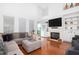 Spacious living room with tall ceilings, a fireplace, built-in shelving, and hardwood floors at 120 Fresh Meadow Ln, Mount Pleasant, SC 29466