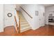 Entryway staircase with wood railing and carpeted steps, with hardwood floors in the entryway at 120 Fresh Meadow Ln, Mount Pleasant, SC 29466