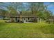 Brick home featuring a charming backyard with a fireplace, patio, and lush green lawn at 123 Tiffany Ln, Summerville, SC 29485