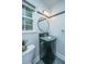 A stylish bathroom with a round mirror, modern lighting, and a unique corner vanity at 123 Tiffany Ln, Summerville, SC 29485
