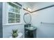 A stylish bathroom with a round mirror, modern lighting, and a unique corner vanity at 123 Tiffany Ln, Summerville, SC 29485