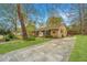 Traditional home featuring an attached drive, brick facade, black shutters, and a green lawn at 123 Tiffany Ln, Summerville, SC 29485