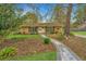 Charming single story home featuring manicured lawn, brick facade, and inviting stone walkway at 123 Tiffany Ln, Summerville, SC 29485
