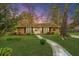 Charming single story home at dusk with manicured lawn, brick facade, and stone walkway at 123 Tiffany Ln, Summerville, SC 29485