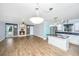 Open-concept living space with a fireplace, kitchen island, and ample natural light at 123 Tiffany Ln, Summerville, SC 29485
