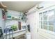 This storage room includes shelving, a utility sink, and a back door leading to the yard at 123 Tiffany Ln, Summerville, SC 29485