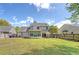 Large backyard with green grass, a patio, a sun room, and a privacy fence at 1310 Belhaven Dr, Mount Pleasant, SC 29466